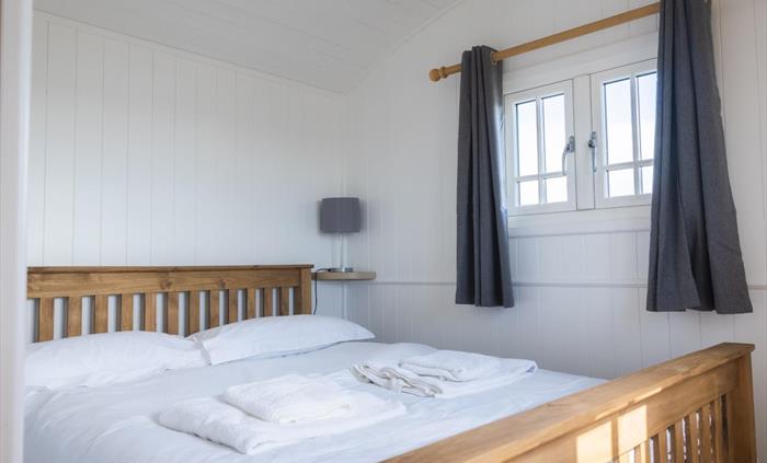 Double bed with crisp, white bed linen